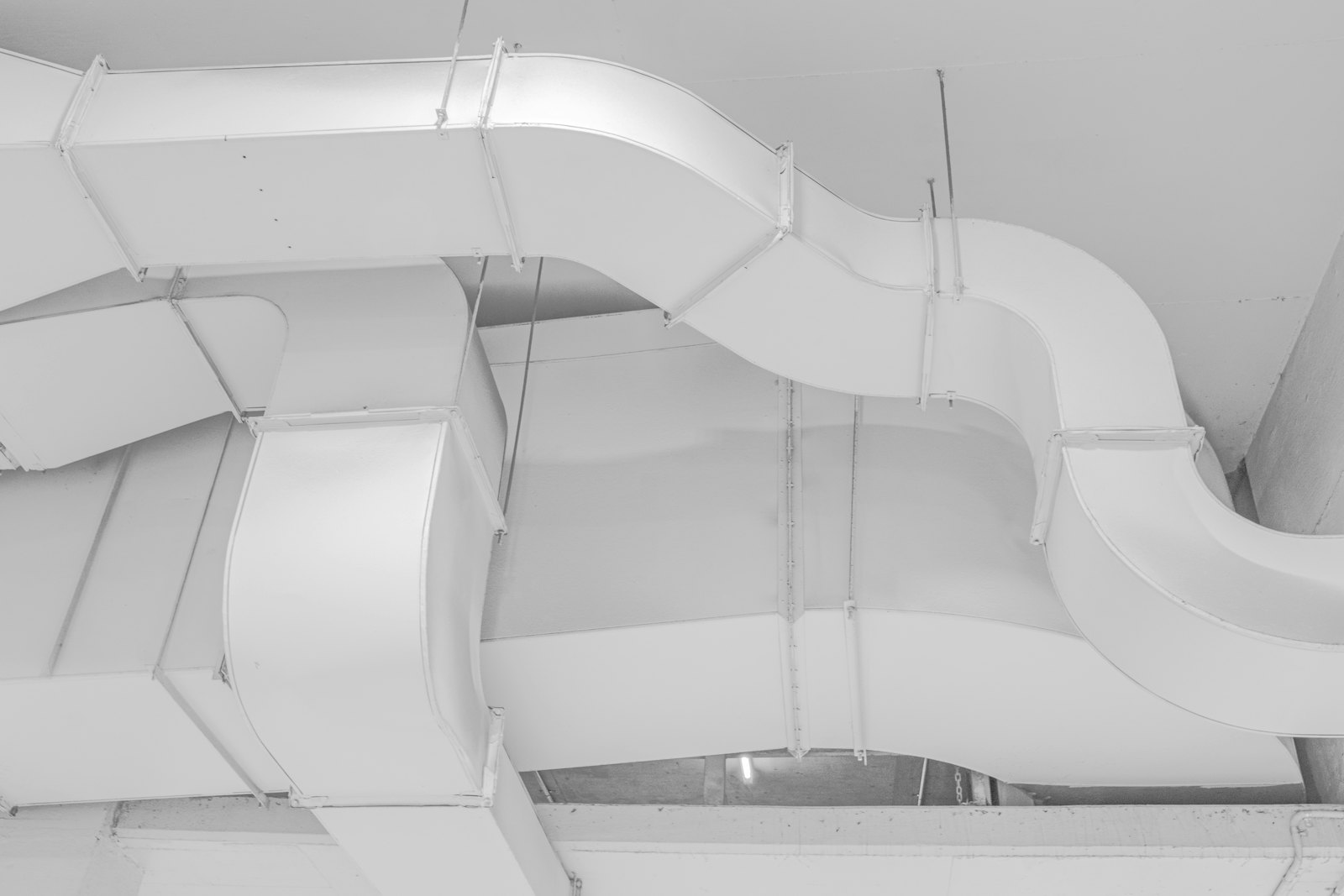 Sheet metal ductwork and diffuser above a suspended ceiling grid