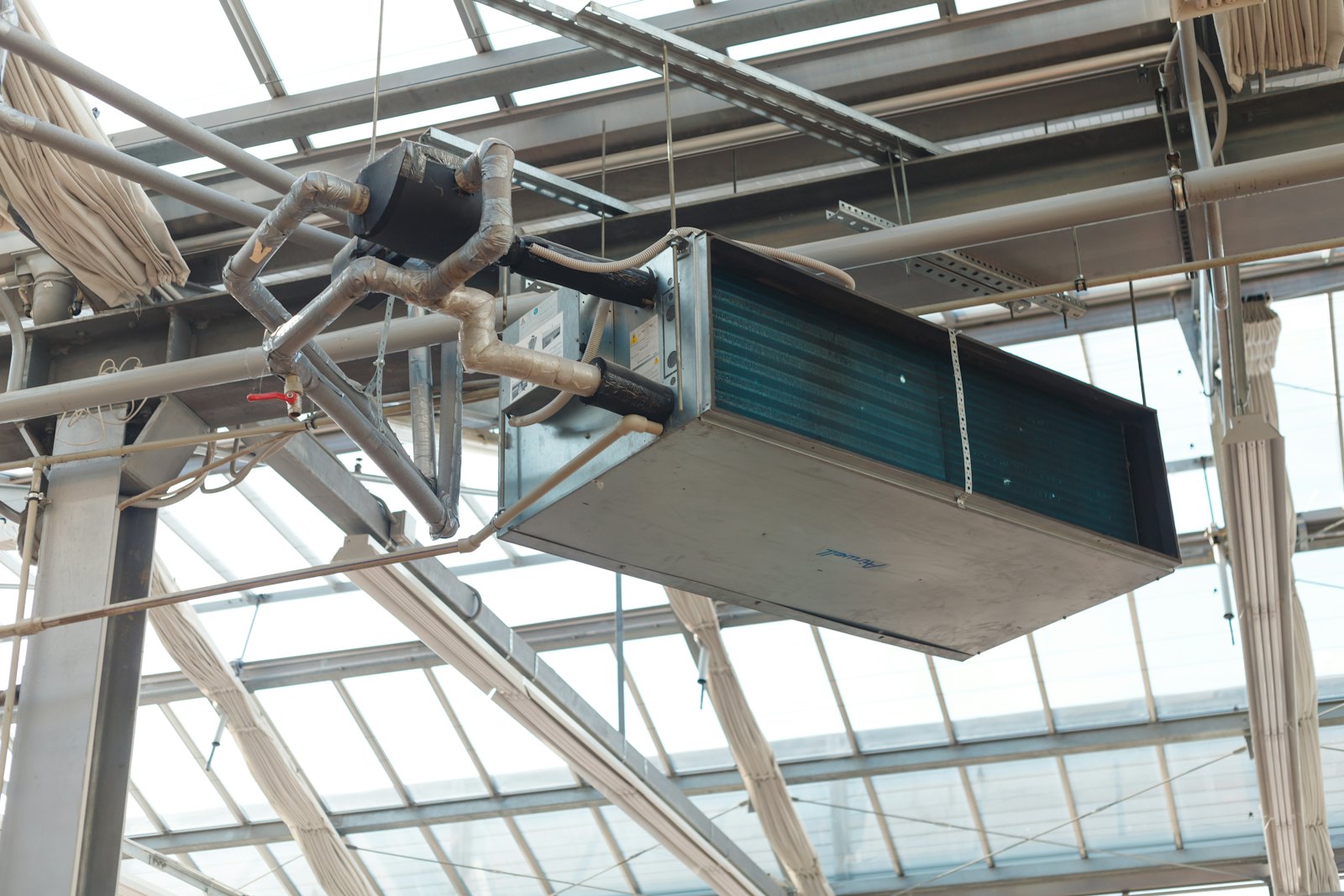 Technician inspecting a condenser coil during a scheduled maintenance visit