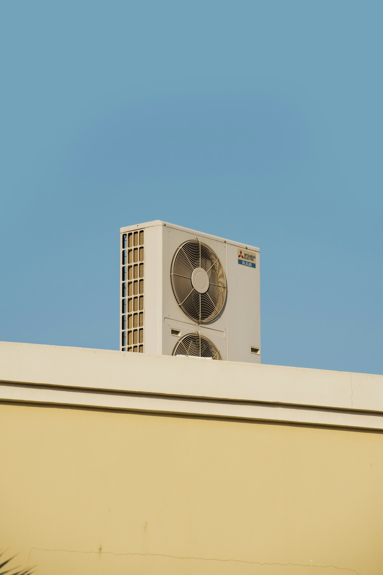 Open access panel on a commercial package rooftop unit showing the compressor section